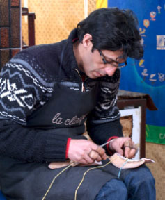 Kamal Boukentar working on a handmade football